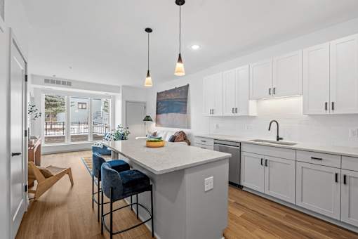 A kitchen with a white countertop and blue chairs.