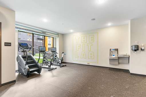 A gym room with a sign that says "The Fit Lab".