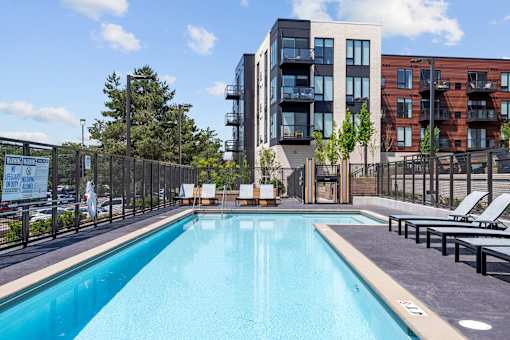 A swimming pool in front of a modern building.