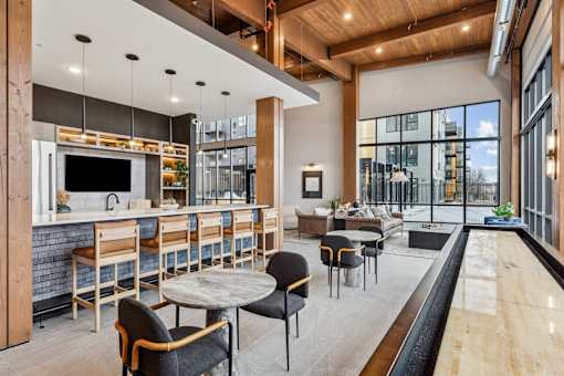 A modern kitchen and dining area with a bar and seating.