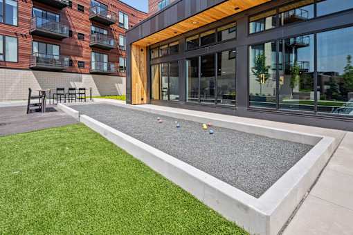 A modern building with a green lawn in front.