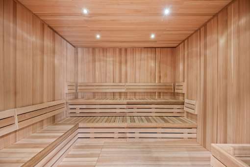 A wooden sauna with benches and a wooden floor.