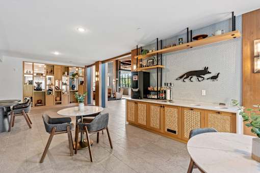 A modern kitchen with a dining table and chairs.