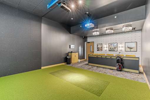 A room with a green floor and grey walls.