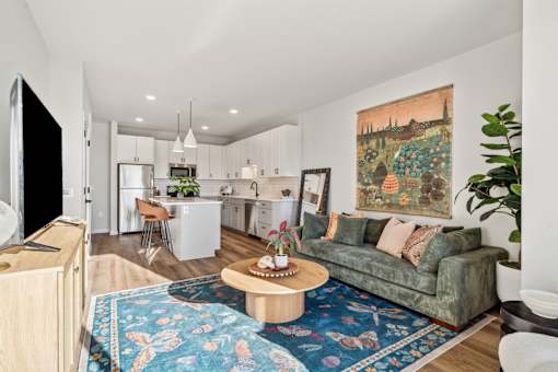 A living room with a couch, a coffee table, and a television.