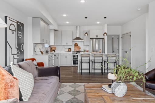 a living room with a couch and a kitchen with an island