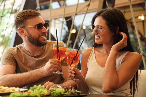 a man and a woman sitting at a table with drinks