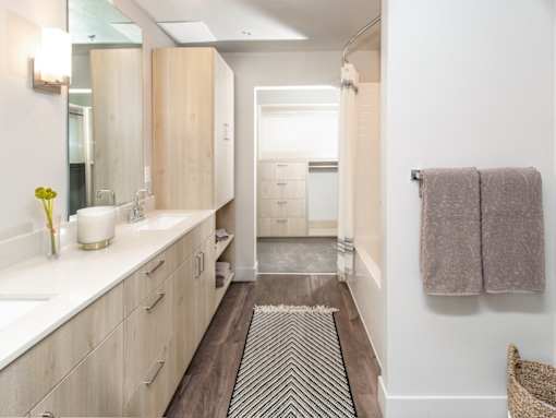 Bathroom with dark wood and light cabinets at Soleil Lofts