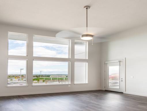 Living room with big windows at Soleil Lofts