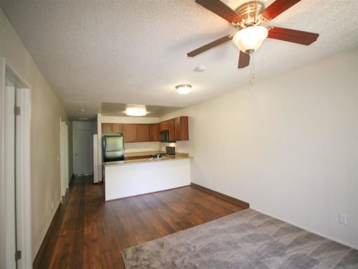 Living Room With Kitchen View at Creekside Villas Apartments, San Diego