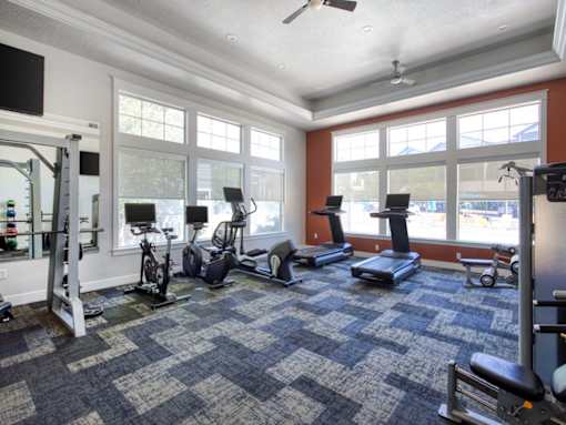 A spacious gym with a variety of exercise equipment at the Talavera at the Junction