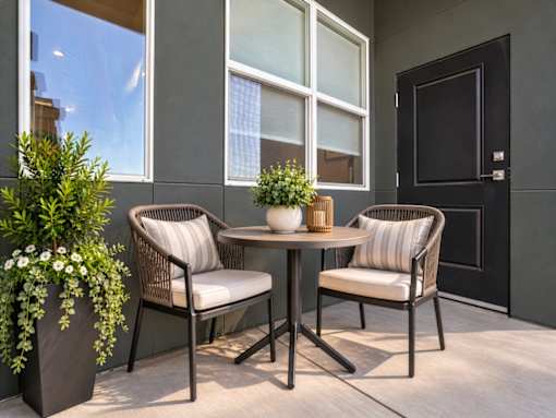 A patio with a table and two chairs.