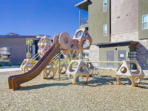 A playground with a slide and a climbing structure.