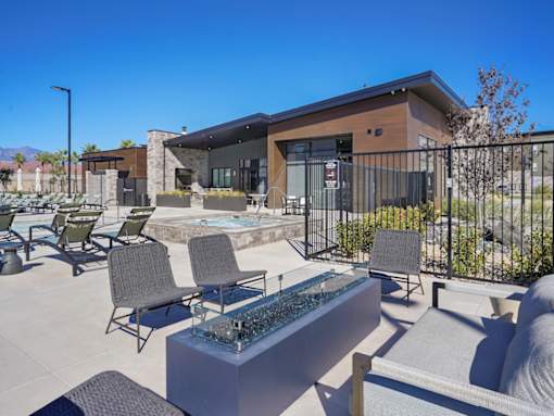 A modern house with a pool and patio furniture.
