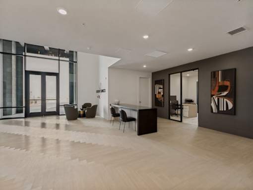 A modern office space with a long wooden table and chairs.