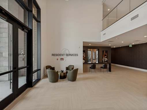 A resident services room with a white wall and a black door.
