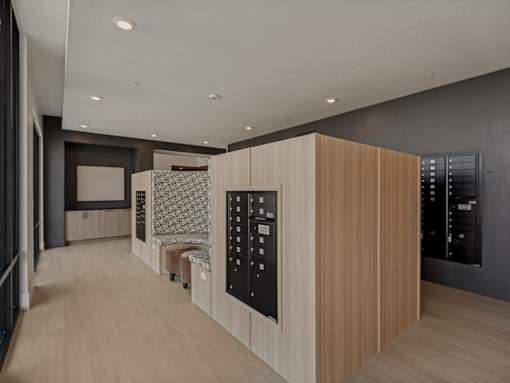 A modern kitchen with wooden cabinets and black appliances.