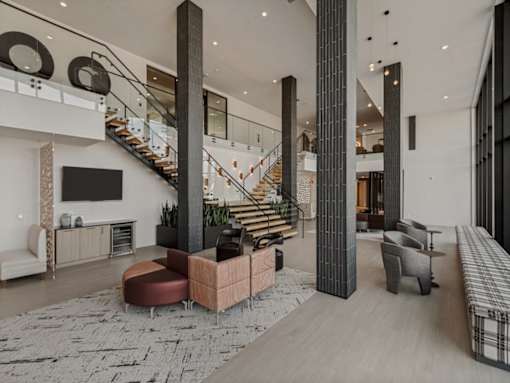 A modern living room with a staircase and a fireplace.
