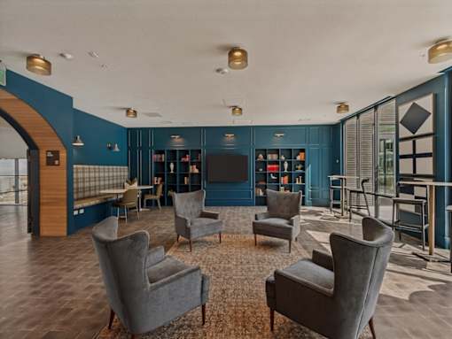 A living room with grey chairs and a wooden floor.