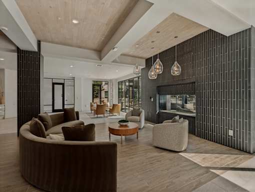 A modern living room with a brown sofa and a wooden coffee table.