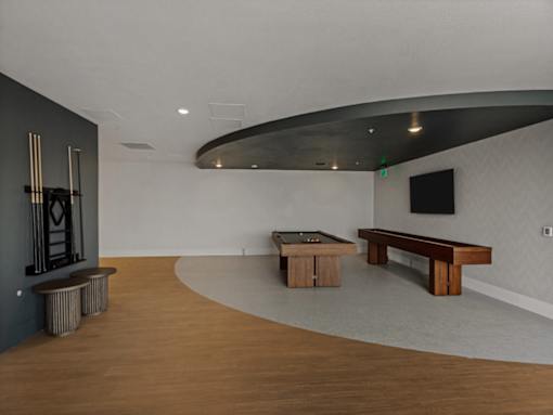 A room with a black wall and a wooden bench.