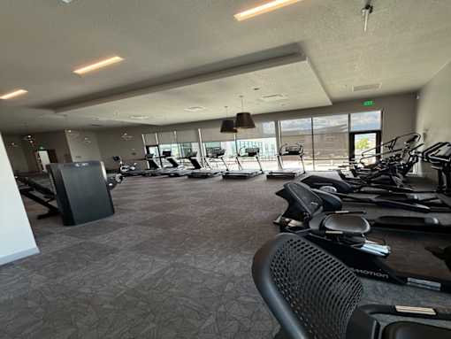 A gym with a variety of exercise equipment.