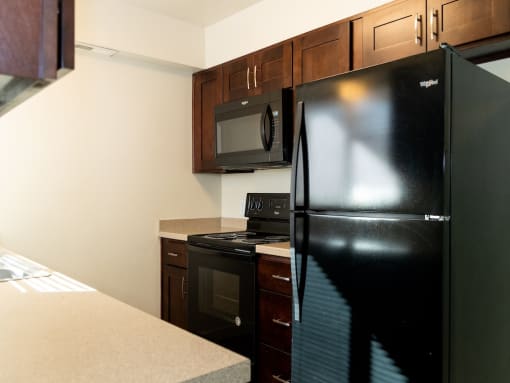 Kitchen with Black Appliances at Crossroads Apartments