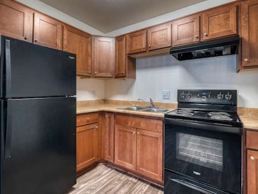Kitchen with Black Appliances at Peppertree