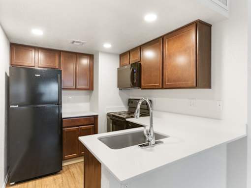Kitchen with Black Appliances at Rio Seco Apartments