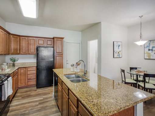 Kitchen with Brown Cabinets at San Tropez