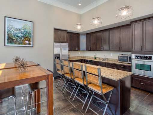 Kitchen with Brown Cabinets in the CLubhoue at the Talavera