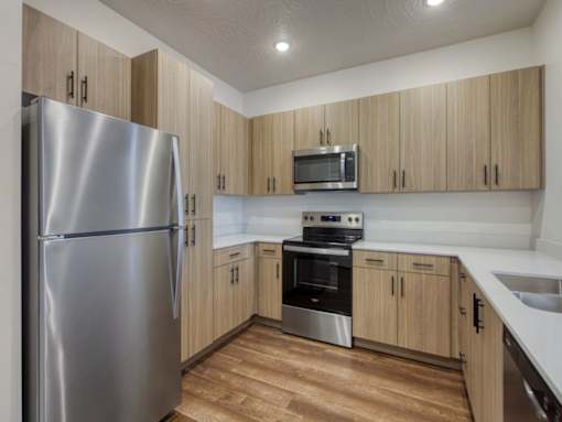 Kitchen with Silver Appliances at The Atlas