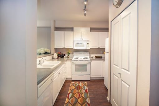 Kitchen With White Cabinetry And Appliances at Metropolitan Place Apartments, Renton, WA, 98057