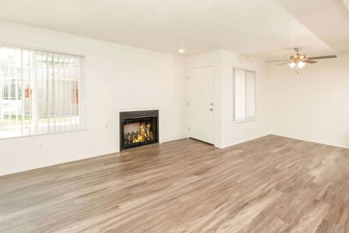 Living Room with Fireplace and Woodgrain Flooring at River Oaks Apartments & Townhomes, California