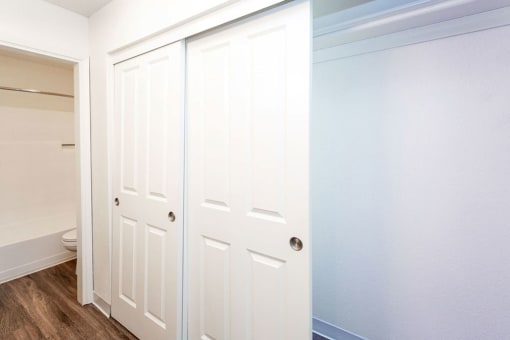Main Bedroom Closet with Panel Doors and Ensuite Bathroom  at River Oaks Apartments & Townhomes, Hanford, CA