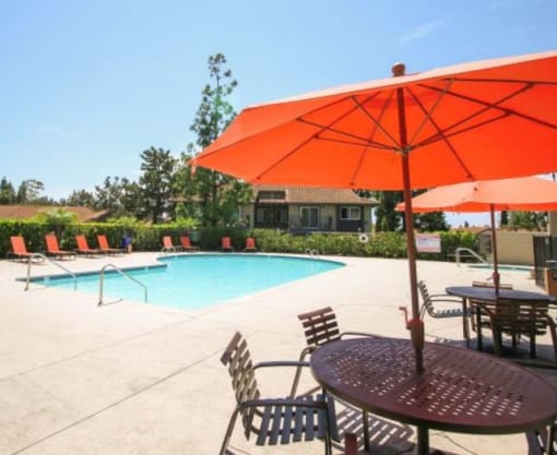 Pool Deck with Umbrella and Table at  Shadow Way Affordable Apartments - Oceanside CA 92057