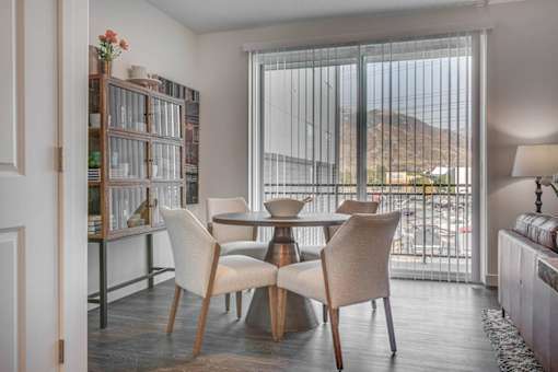 A dining room with a table and chairs.