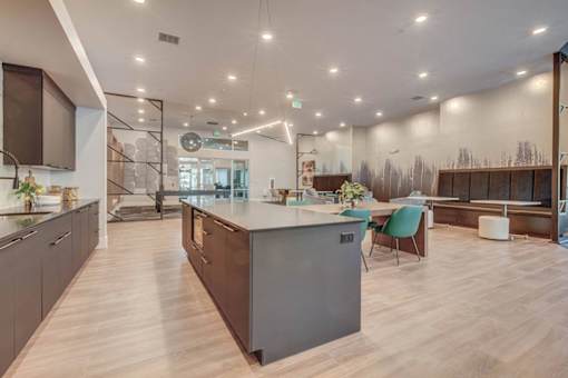 A modern kitchen with a large island and wooden floors.