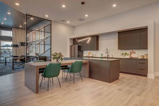 A modern kitchen with a dining table and chairs.