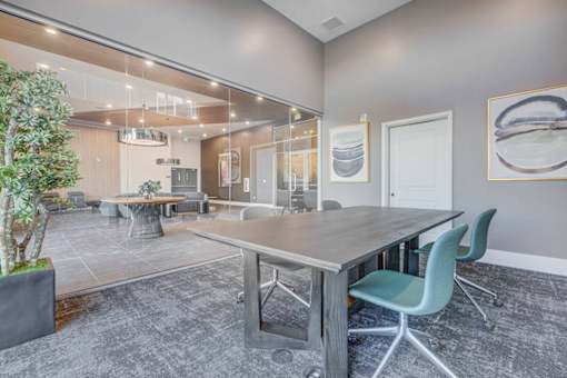 A conference room with a long table and chairs.