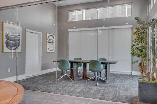 A conference room with a glass table and chairs.