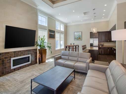A modern living room with a fireplace and a large couch at the Talavera at the Junction