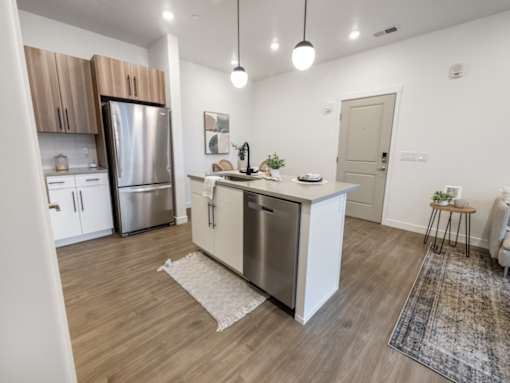 A modern kitchen with wooden cabinets and a white island.