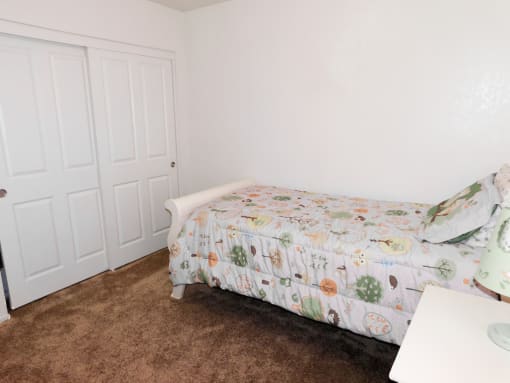 Secondary Bedroom with Double Closet Doors at River Oaks Apartments & Townhomes, Hanford, CA