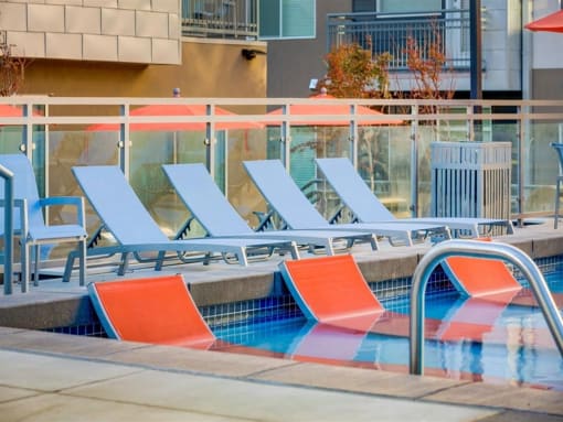 Sparkling Swimming Pool with sitting area in the pool at Element 31 Apartments, Utah