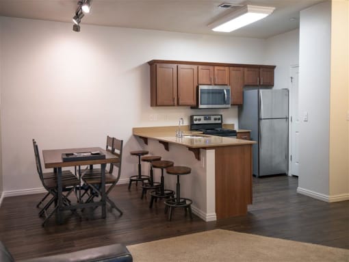 Fully Equipped Kitchen With Island Dining at Four Seasons Apartments & Townhomes, North Logan