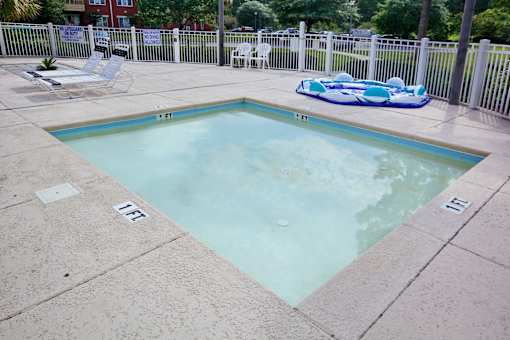 A small pool with a blue inflatable in the middle. Aviary Village Apartments, in Conway, SC 29526