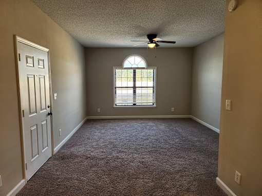 A room with a ceiling fan and a window with blinds. The Cloisters Apartments, 902 67th Avenue North, Myrtle Beach, SC