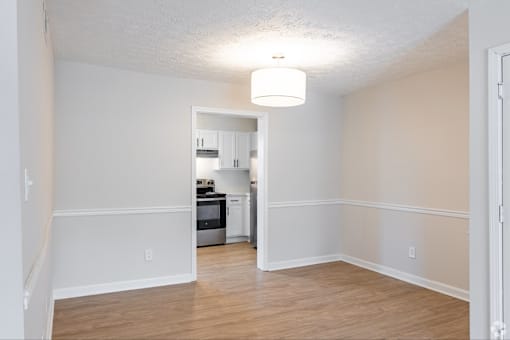 A kitchen area with a refrigerator, oven, and microwave.