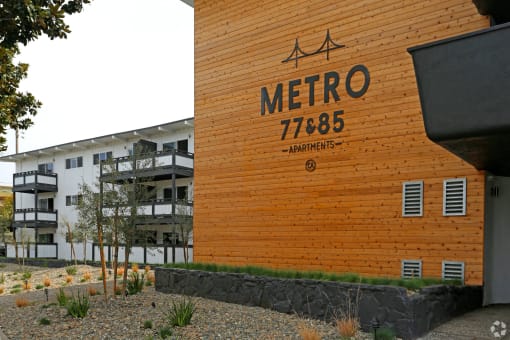Building exterior wooden paneled wall Metro 77& 85 signage